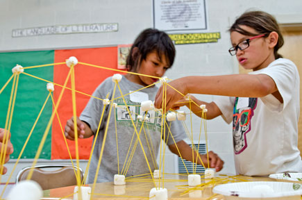 students building with pasta