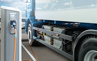 Semi truck plugged into a charging station for electric vehicles