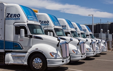 Zero-emissions semi trucks parked in a row