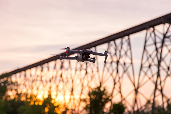 Drone in flight with a bridge in the background