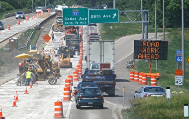 Large road construction zone with equipment and workers