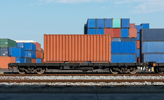 Colorful cargo containers stacked on a rail car