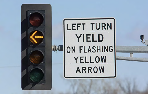 Traffic signal with a flashing yellow arrow and yield sign