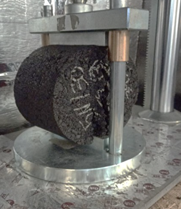 An asphalt core being tested in the lab